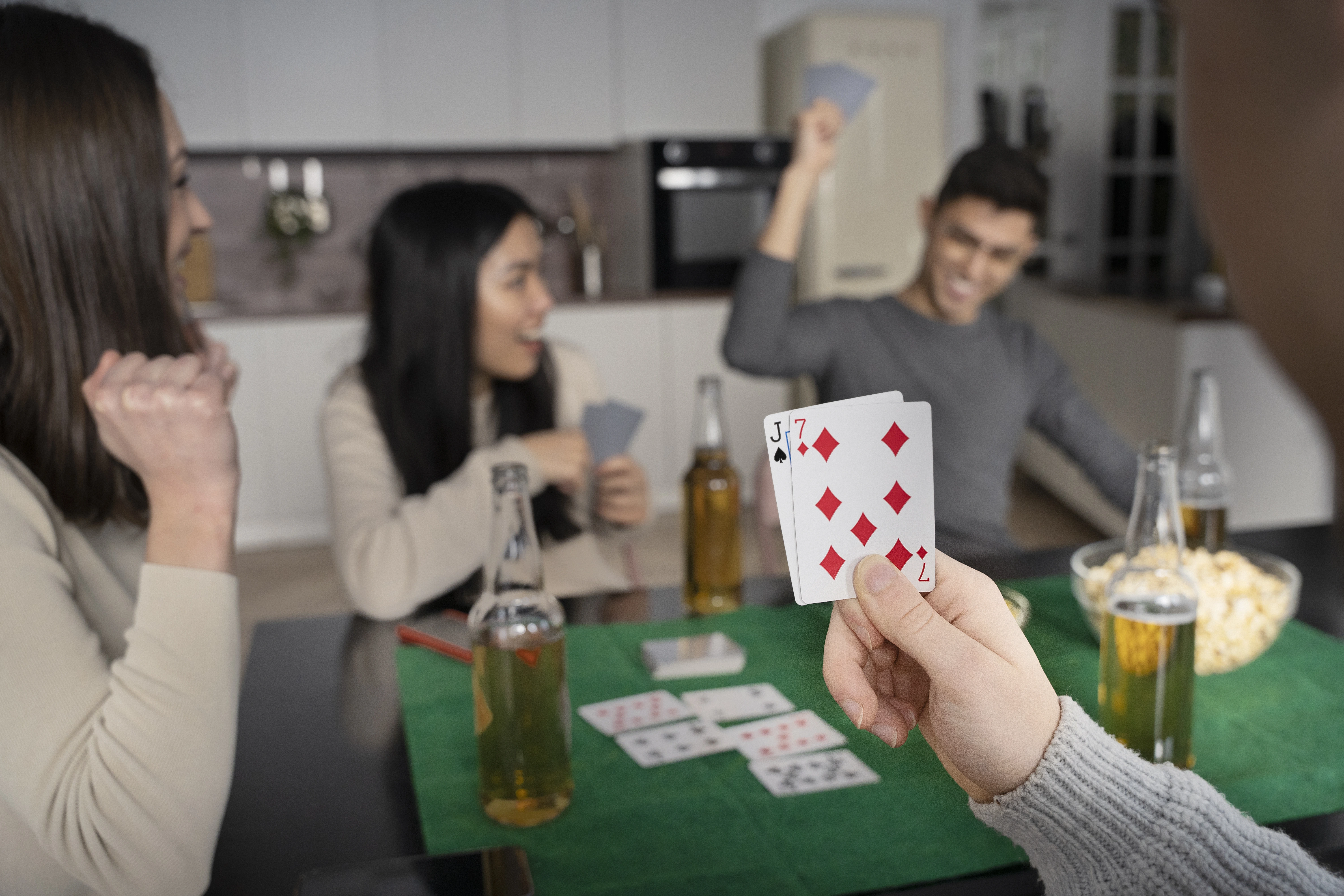 A group of friends playing black Jack together showing  excitement and happiness together